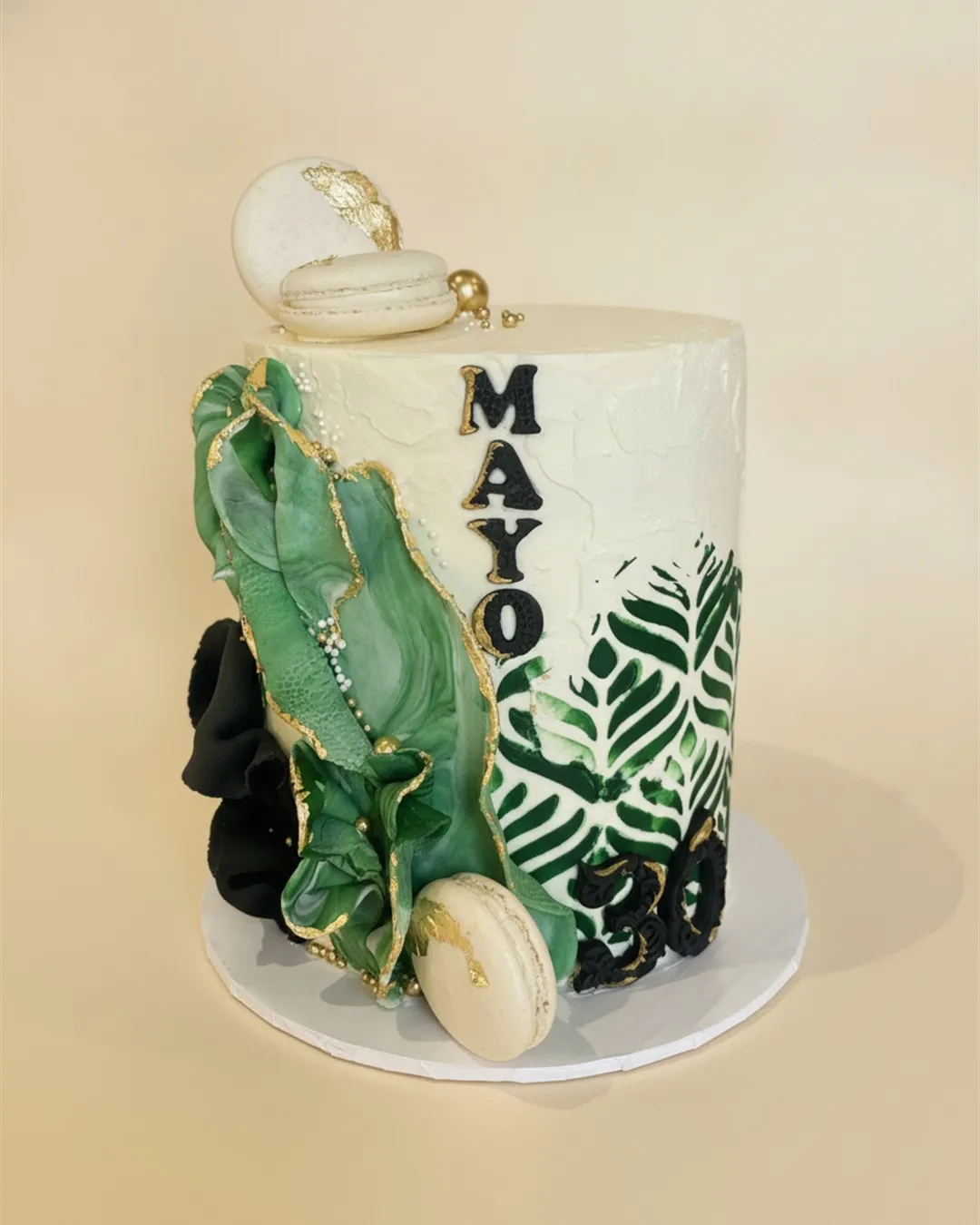 Ivory cake with green agate marbling, gold leaf edging, painted leaves and macarons